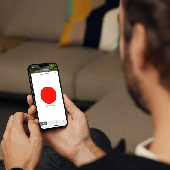 A man checking the status of his Conexis ® L2 Smart Door Lock