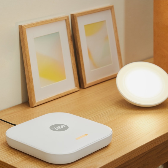 A Yale Home Smart Hub on a side table