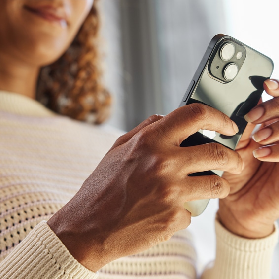 Woman remotely speaking to someone at her front door via the Yale Smart Video Doorbell